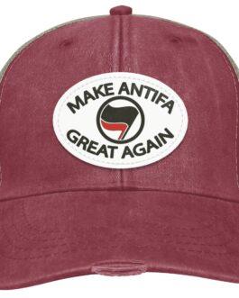 Distressed nautical red "Make Antifa Great Again" hat. This Adams trucker cap features a vegan leather patch with the Antifa flag on an oval. The cap has a worn, vintage look.