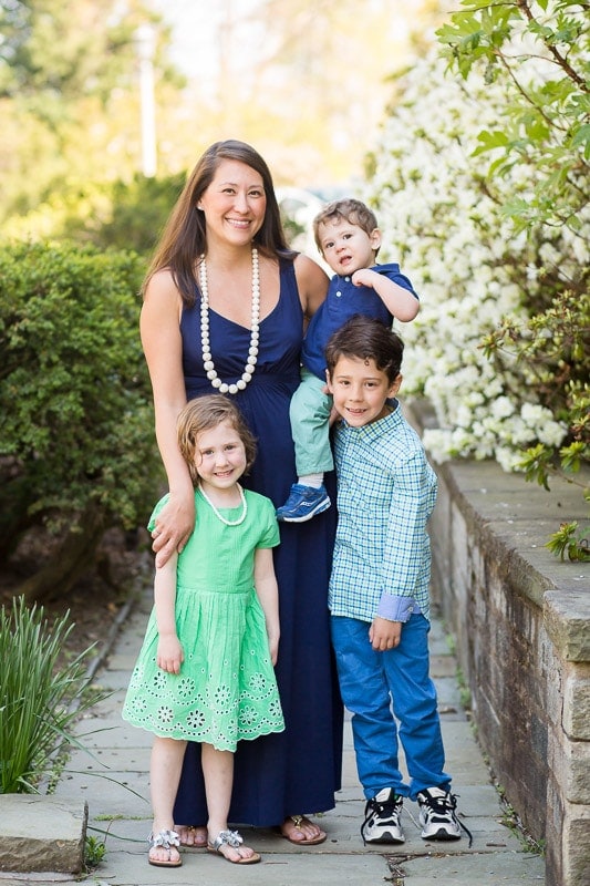 Mother joined her three children to pose on a stone walkway at the National Cathedral for sibling photo session in Washington, DC.