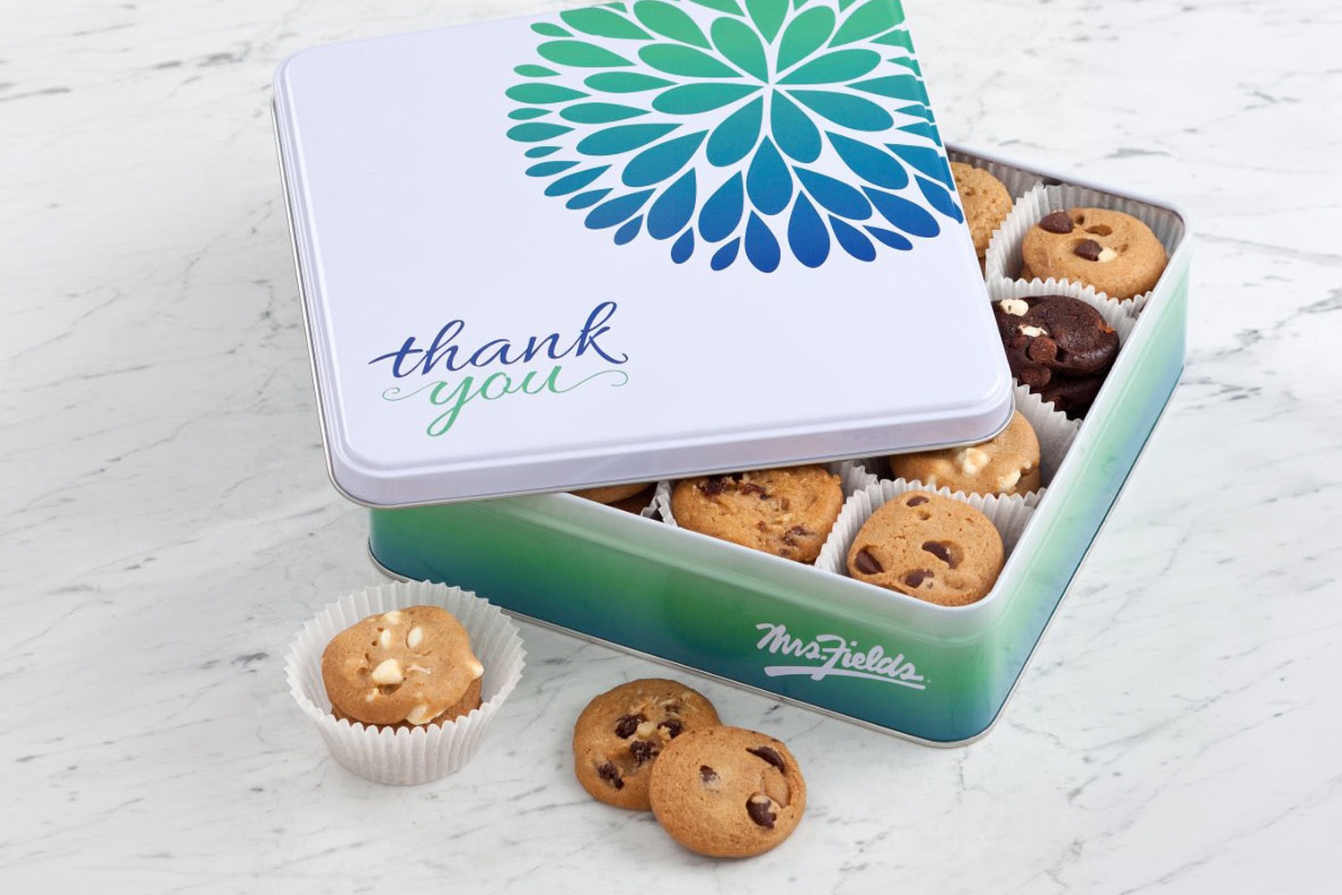Cookie tin with assorted cookies; Mrs. Fields