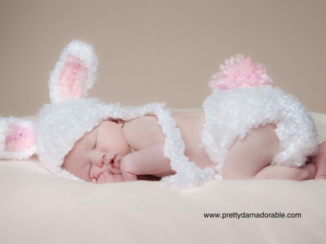 baby asleep with white and pink crochet bunny hat and diaper cover with floppy ears