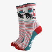 Playful Christmas socks featuring mischievous black cats