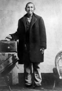Pokagon ph 3437 resize Old man with vintage suitcase and walking cane, historical photograph from the 19th century.