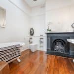 A living room with a sink and a mirror