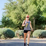 Woman jogging outdoors with water bottle