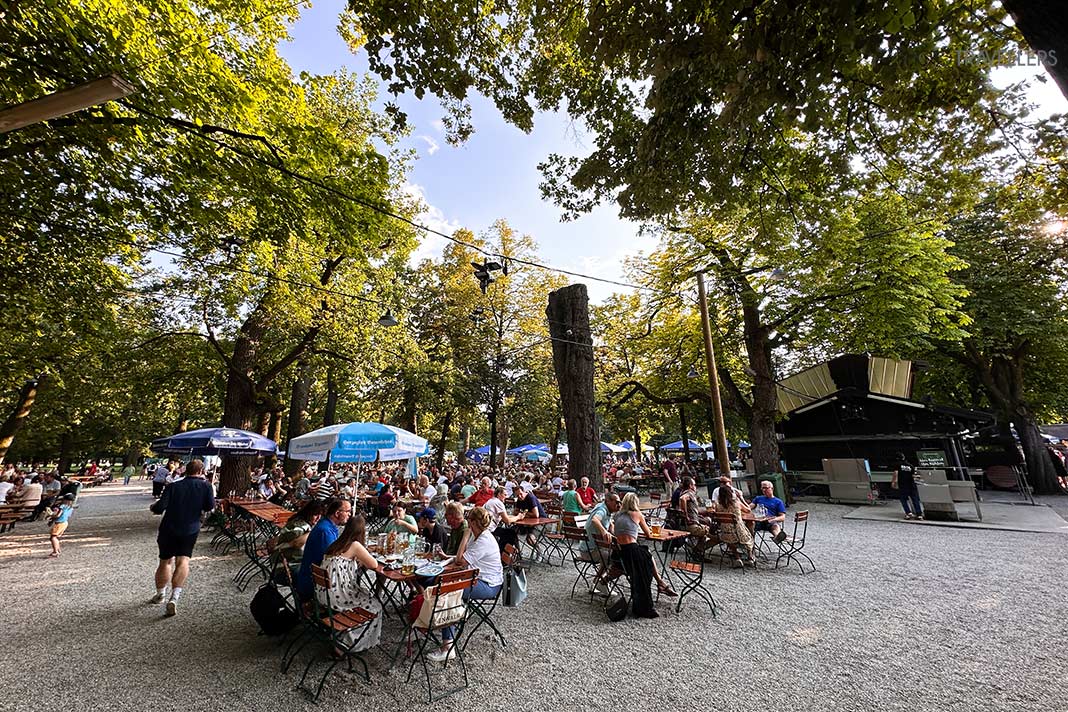 Besucher an Tischen im Königlichen Hirschgarten in München