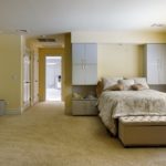 A bedroom with a large bed in a room