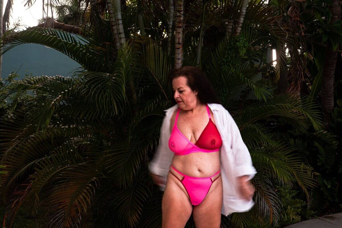 boudoir over 40, a great way to empower yourself. This photograph has motion blur and is of a sixty year old woman wearing a beautiful pink bra and panty set in Los Angeles