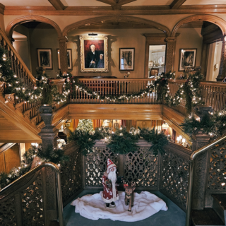 Copshaholm Christmas_retouched Festively decorated historic interior of The History Museum featuring Christmas garlands, ornaments, and Santa Claus with reindeer, highlighting museum's preserved architecture and holiday exhibits.