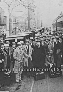 streetcar - ND FB team c.1926 ph 4490 Group of people waiting at a train station in early 20th century, historical transportation scene.