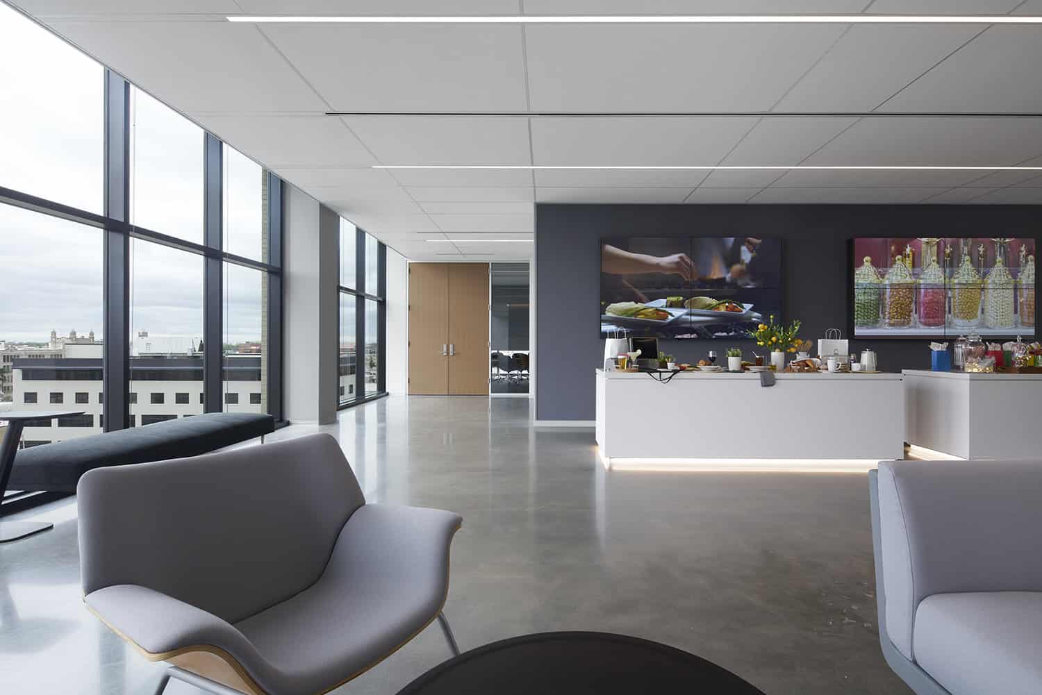 Break area at Heartland Headquarters in Oklahoma City, featuring modern seating, large windows, and a refreshment counter."