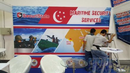 Installing Fabric banner with Velcro on 4 x 3 Exhibition panels at Marina bay Sands