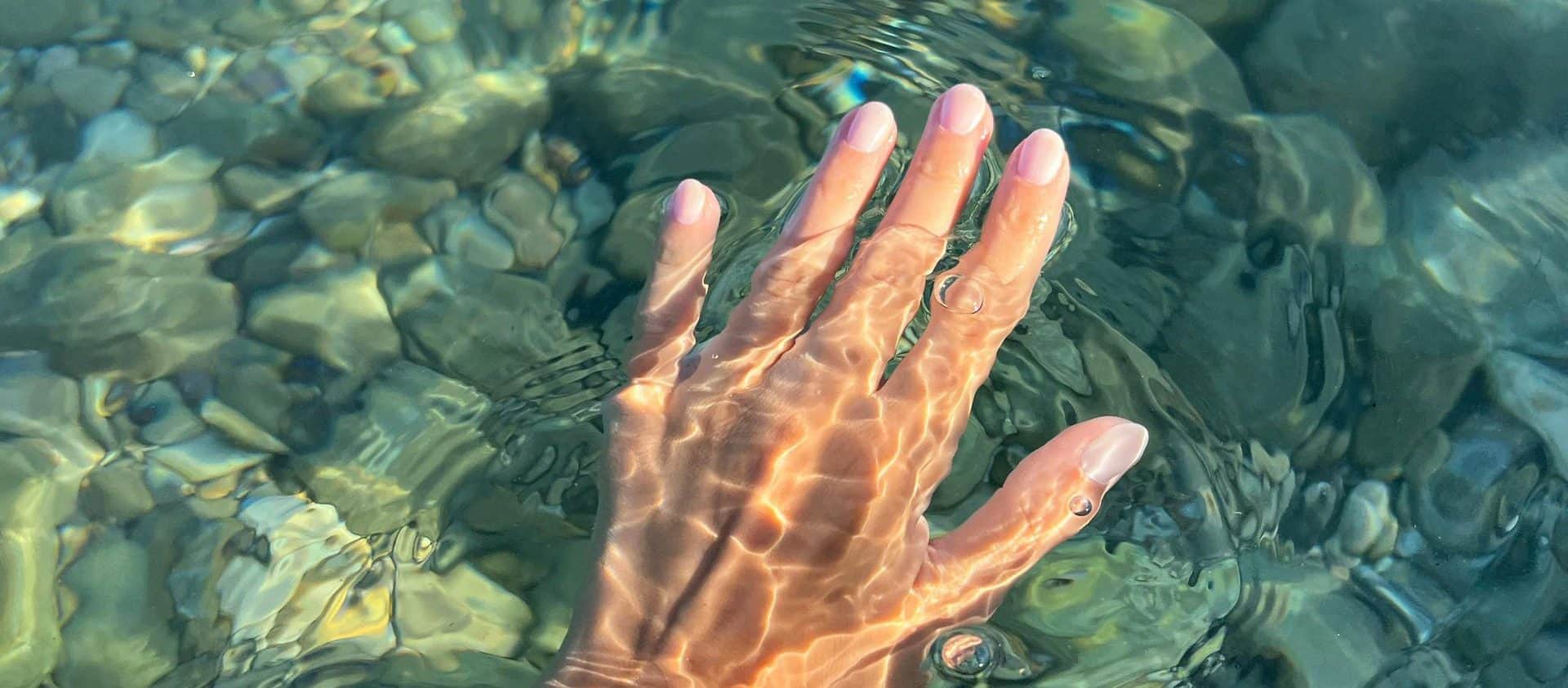 Hand in clear water