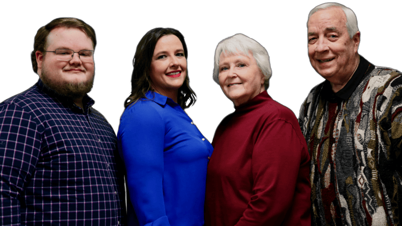 A group portrait of four individuals representing a family owned insurance agency, standing together against a black background.