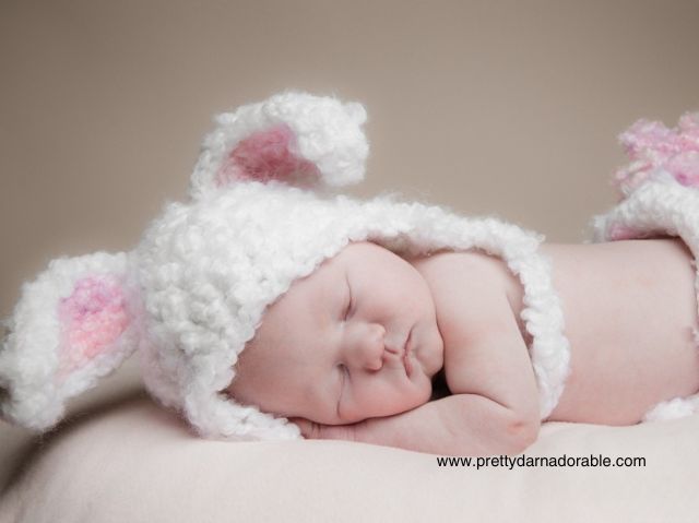 baby asleep with white and pink crochet bunny hat with floppy ears