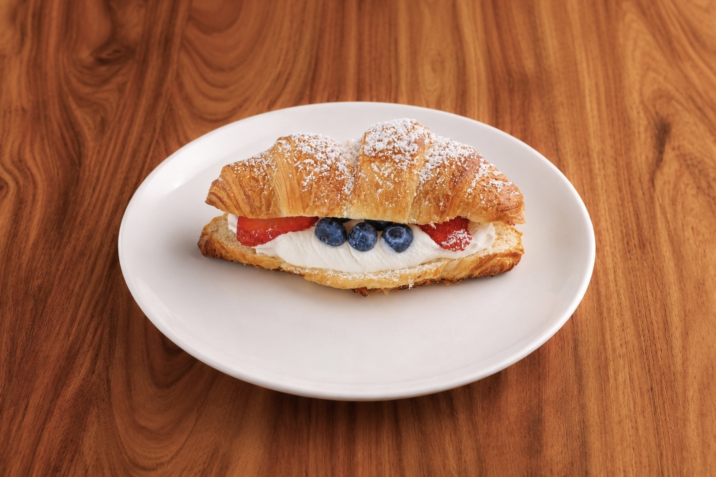 Red, White & Blue Croissant with strawberries and blueberries on a white plate