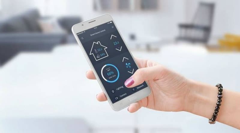 Hand holding cell phone with icons on screen - Eco-Home Boiler Installation