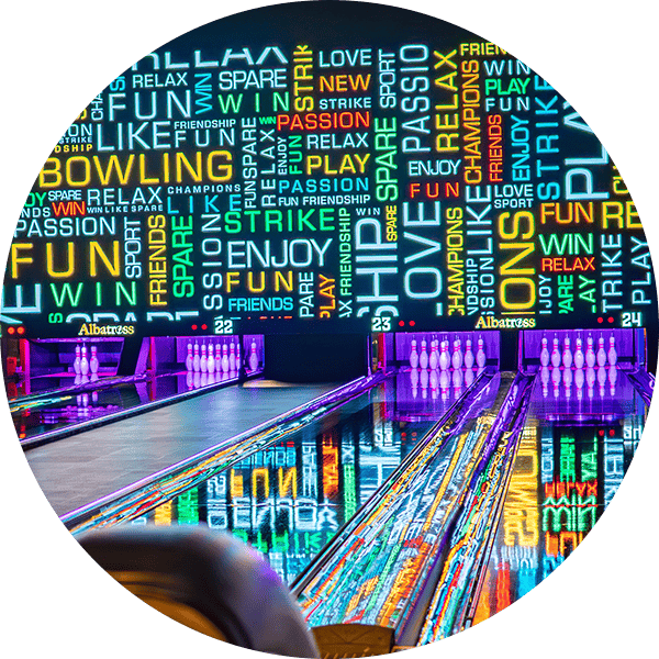 Vibrant neon-lit bowling lanes with colorful word art backdrop, perfect for fun and entertainment.