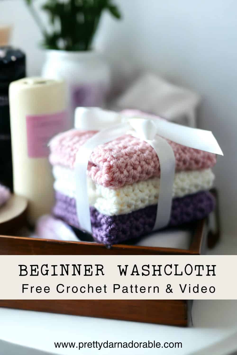stack of crochet washcloths in purple pink and cream with a bow