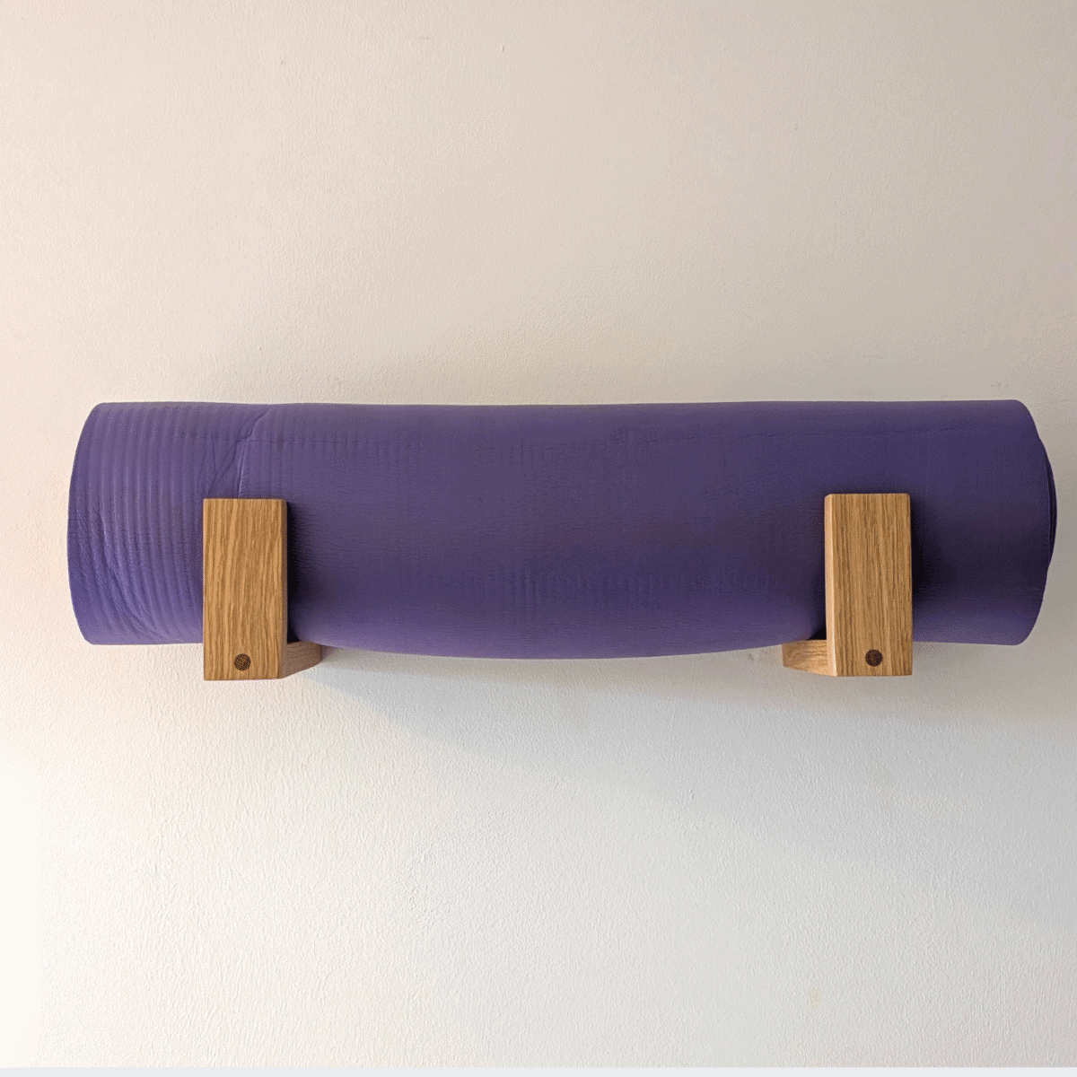 Solid Oak yoga mat hooks - wall mounted close together with mat overhanging