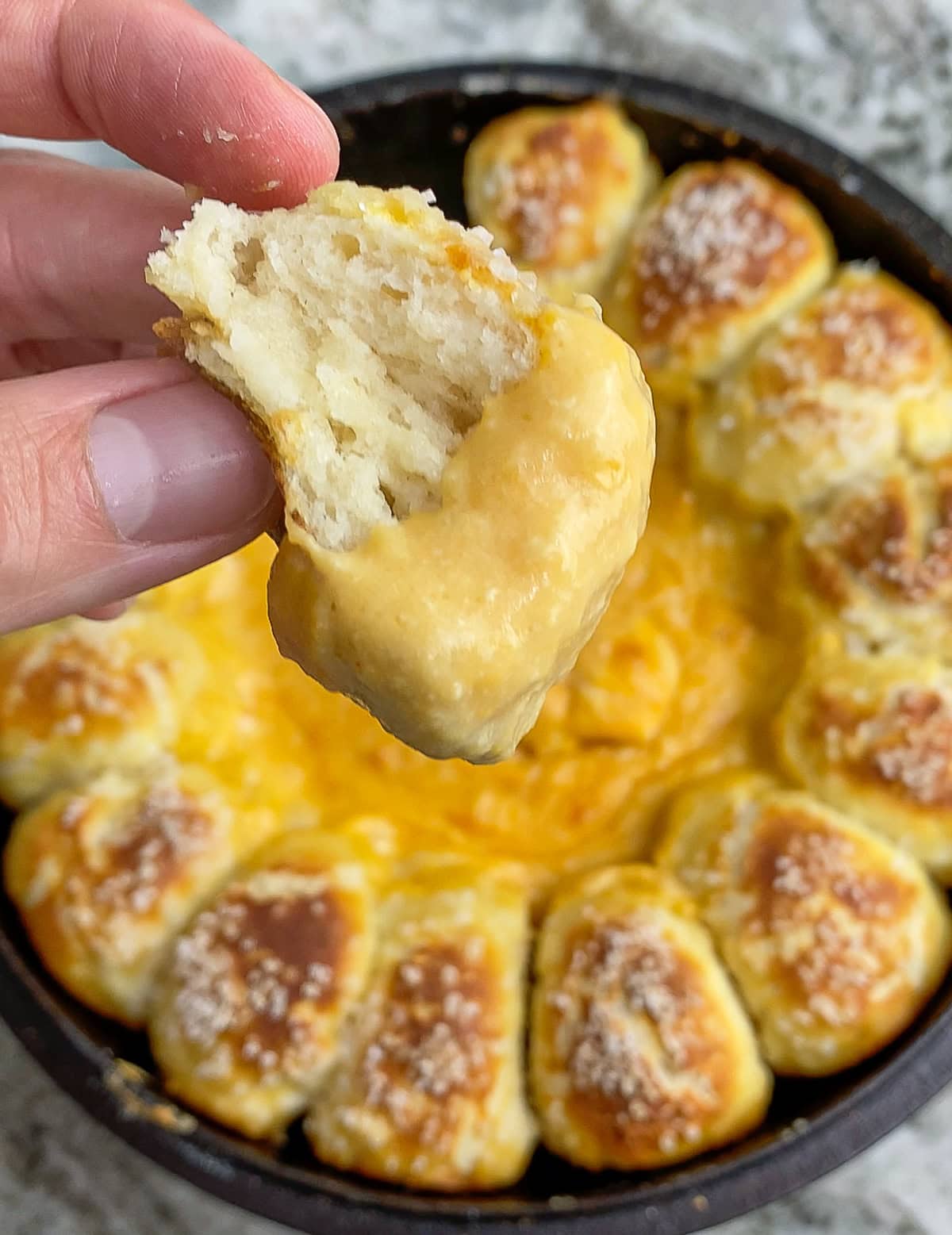 Pretzel dipped in beer cheese