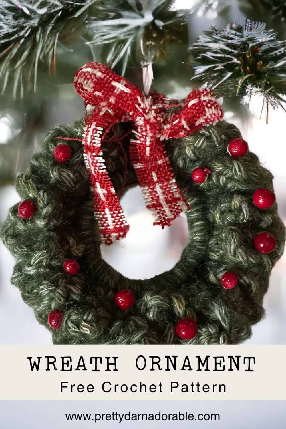 green mini crochet wreath ornament hanging on a tree