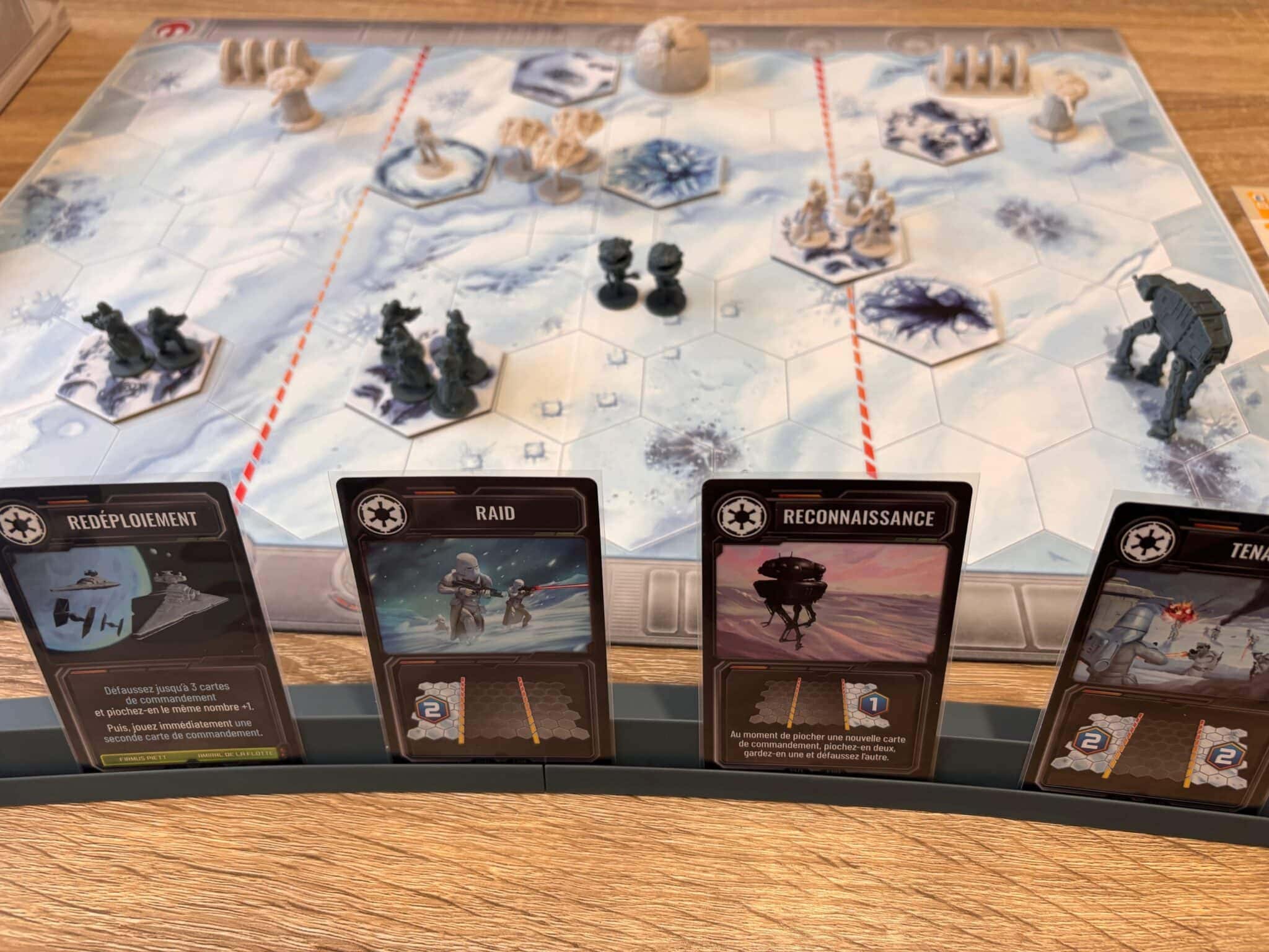 Fichiers de jeu de société Star Wars: Outer Rim avec des cartes et des figurines dans un décor enneigé, illustrant un gameplay stratégique et immersif dans l'univers de Star Wars, idéal pour les fans de jeux de stratégie et de science-fiction.