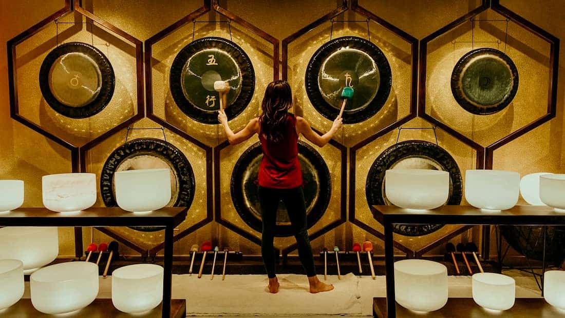 Woman playing tow gongs
