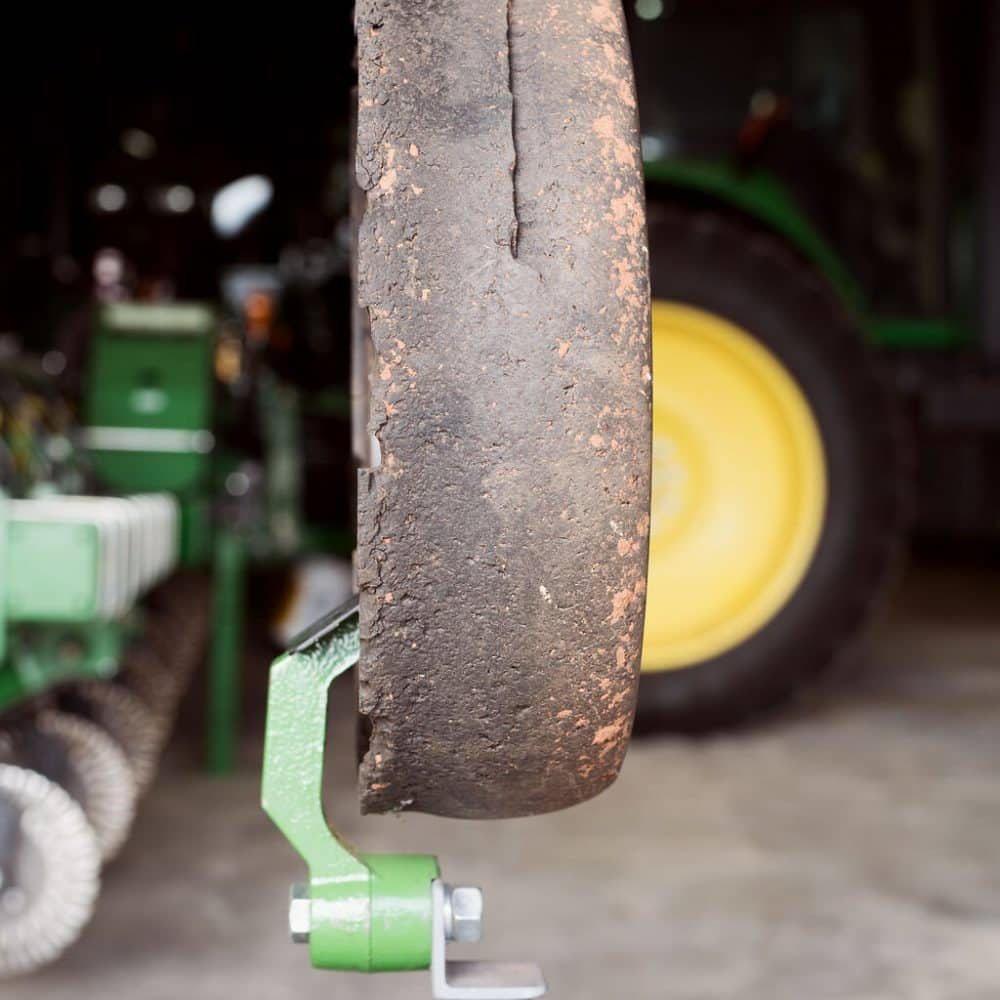 Close-up of an OEM tire showing visible signs of wear and deterioration, highlighting cracks and damage caused by long-term use.
