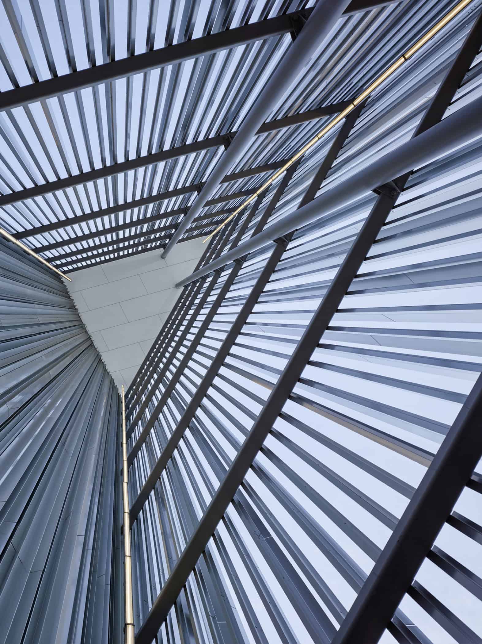 Looking up at the intricate aluminum fin design of the Oklahoma Contemporary Arts Center, capturing the interplay of light and structure.