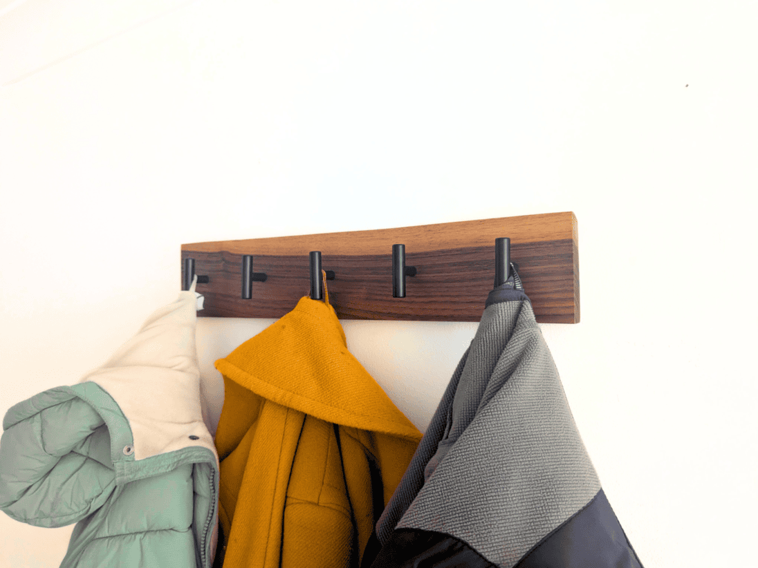 Modern Solid Black Walnut Coat Rack with Customizable Hooks - angled view with coats