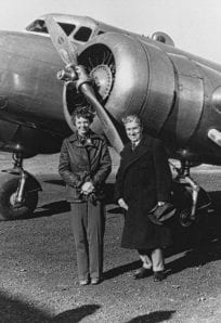 Amelia Earhart ph 7323 Vintage aircraft and two women standing in front, black and white photo from History Museum archives.