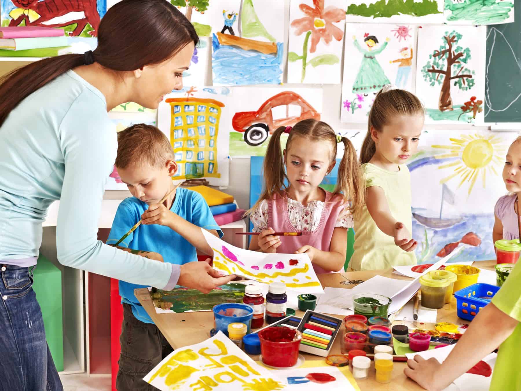 Children with teacher at school. Arts & Craft