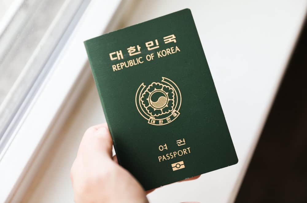 Hand holding Korean passport, related to passport name change arrest case