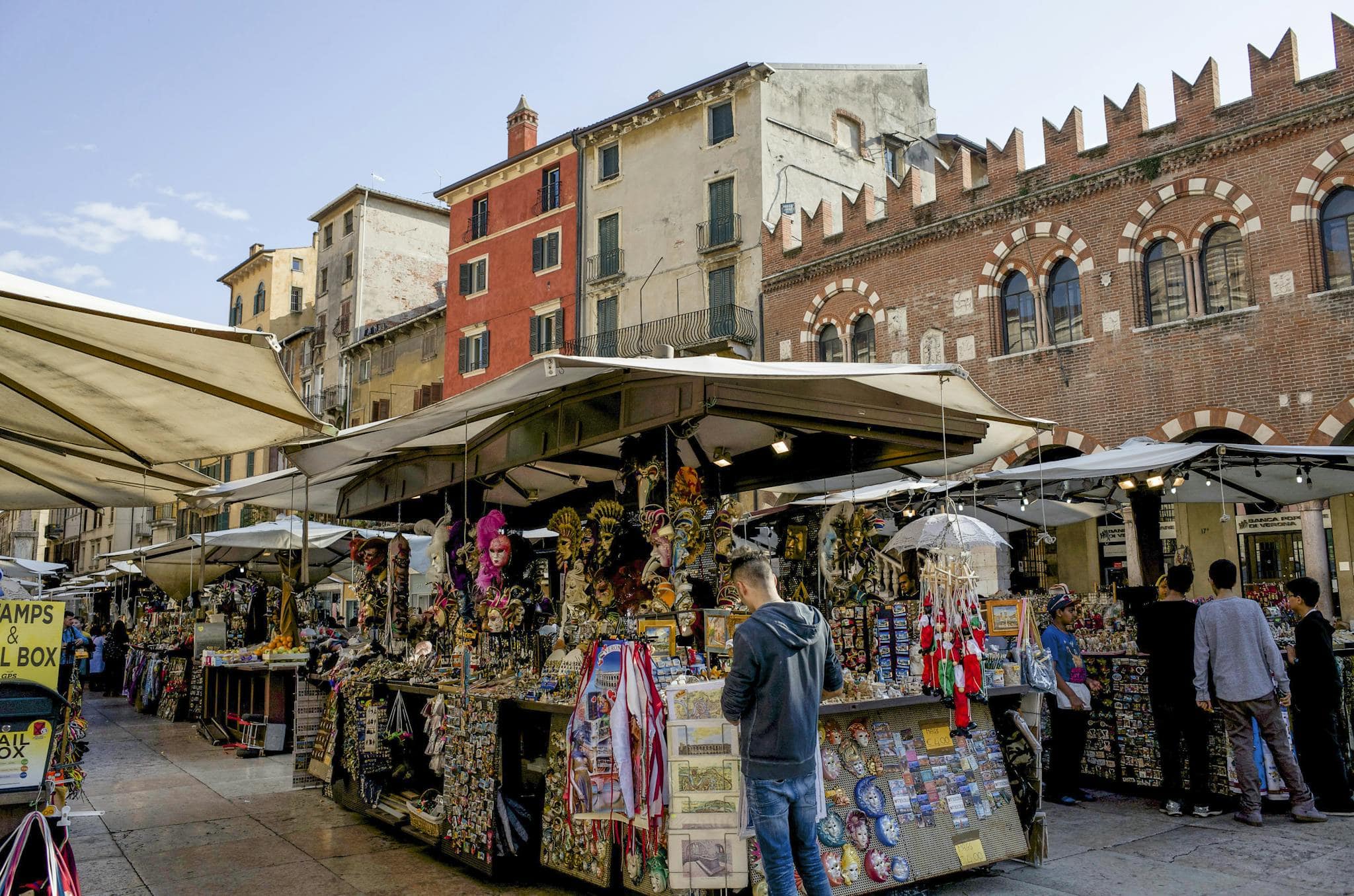 Lively street market scene in Verona, showcasing local crafts and architecture.