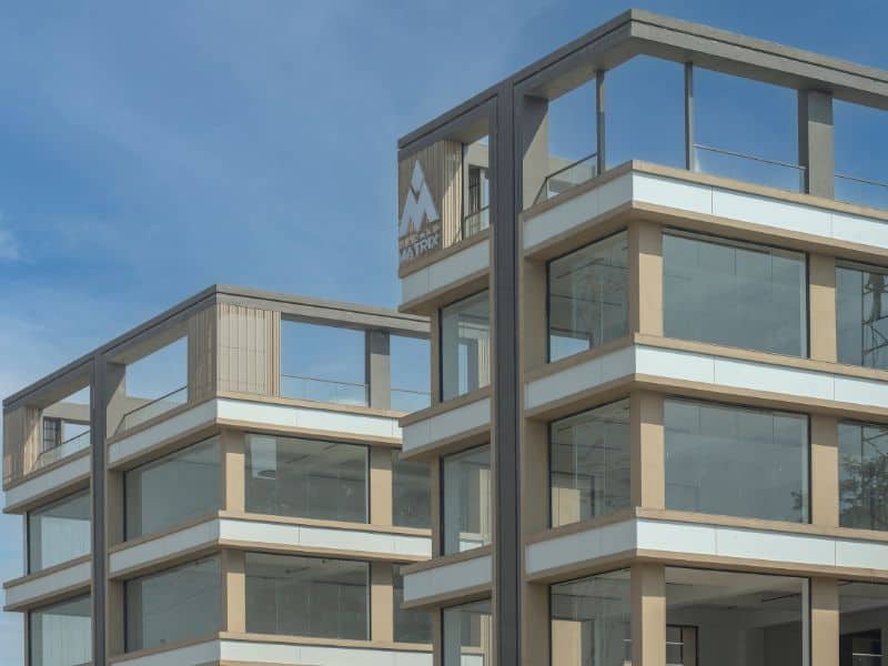 Akshar Matrix, Ahmedabad — modern façade in AluWall Pastel White ACP (AW509).