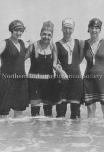 Adele Studebaker ph1647 (1) Women in early 20th-century bathing costumes at the lake, representing historical fashion and leisure activities.
