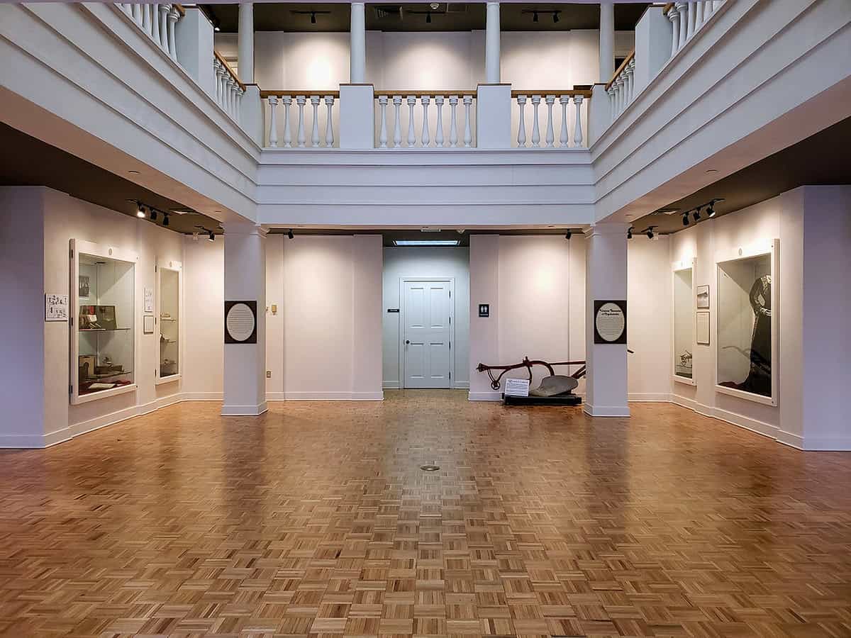 Leighton SD Victorian-style museum exhibit hall showcasing historical artifacts and displays in a spacious, well-lit interior at The History Museum.