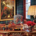 A room filled with furniture and vase of flowers on a table