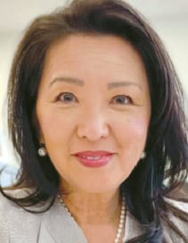 Suzette Rhee Nedrich, Korean American public information officer, smiling in a casual headshot