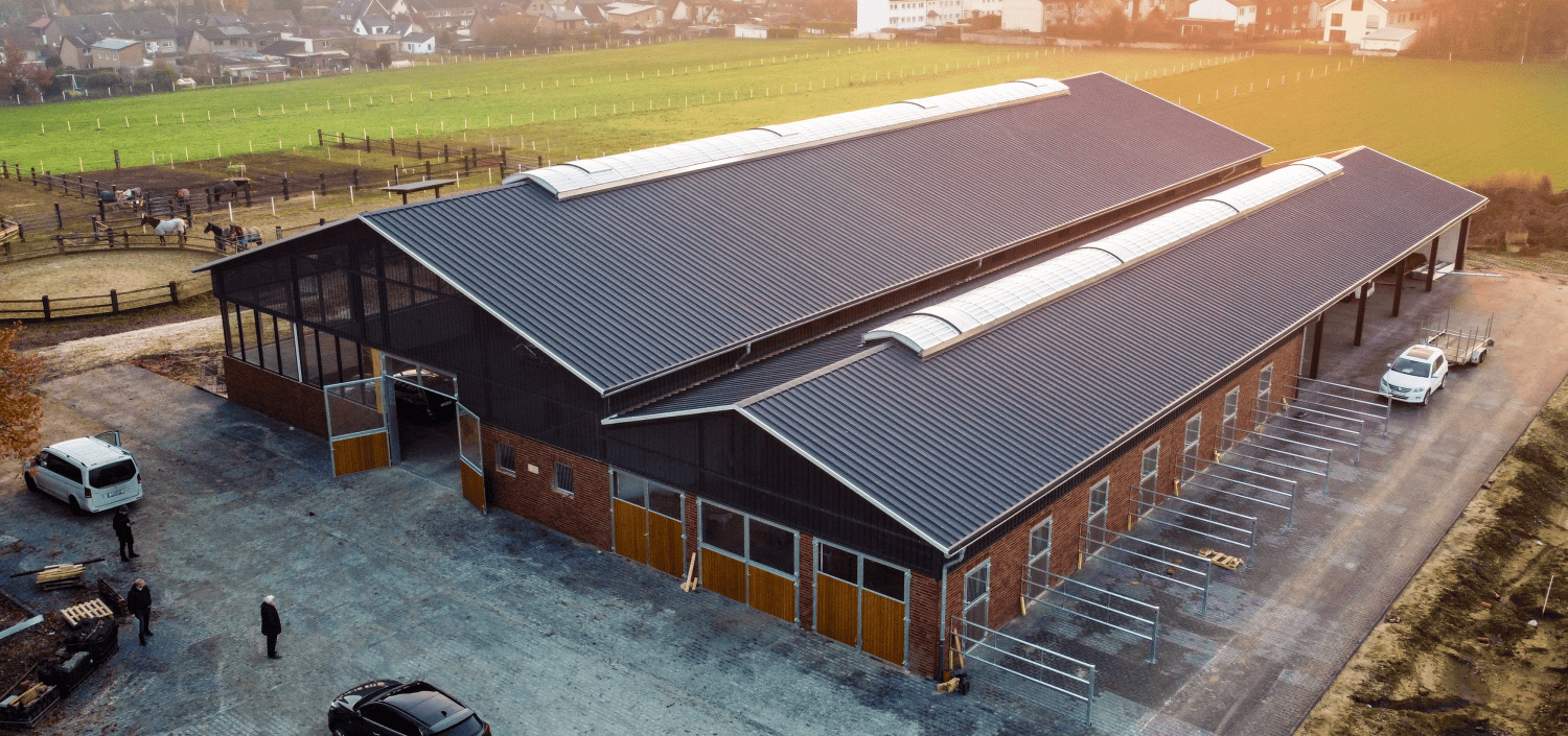 Iso-Dach und Wandpaneele für Mehrzweckhalle, Fassade RAL 9006 abgesetzt mit Kantteilen in RAL 3000, Grundfläche 1200 m2. Baubreite?