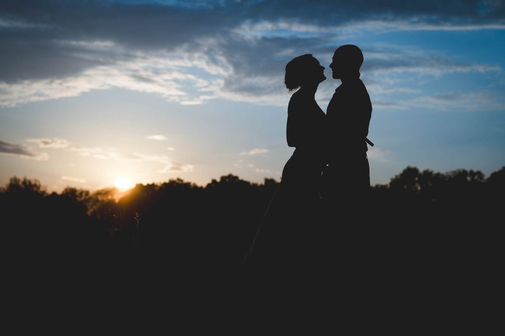 Couple at sunset in a field near Gorcott Hall