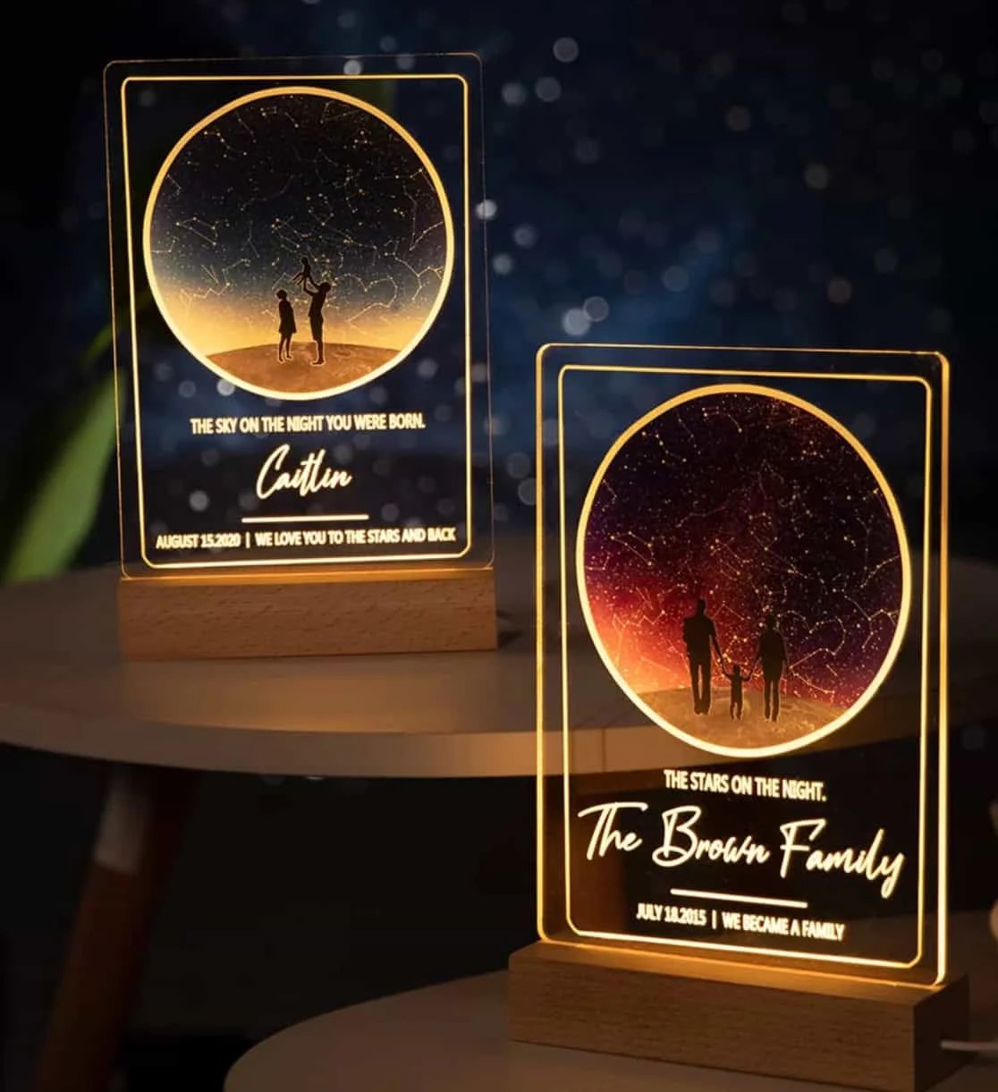 The Custom Night Sky Night Light features two illuminated acrylic plaques on wooden bases, displaying a starry sky and two silhouettes. Personalize each with names, messages, and dates to create a uniquely meaningful gift.