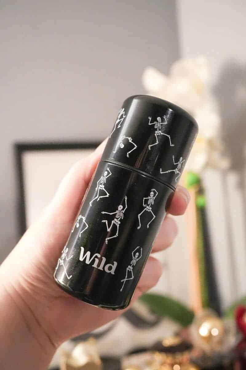 Holding the Wild dancing skeleton Halloween deodorant case