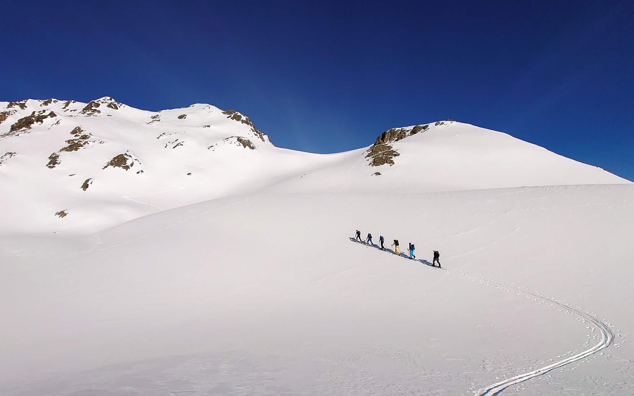 Sunny ascent with skis