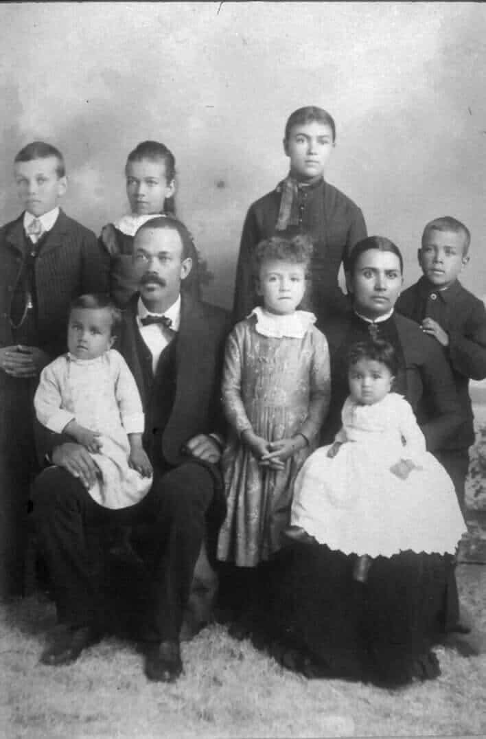 Old family portrait of African American family, vintage black and white photo, 19th-century history museum collection.