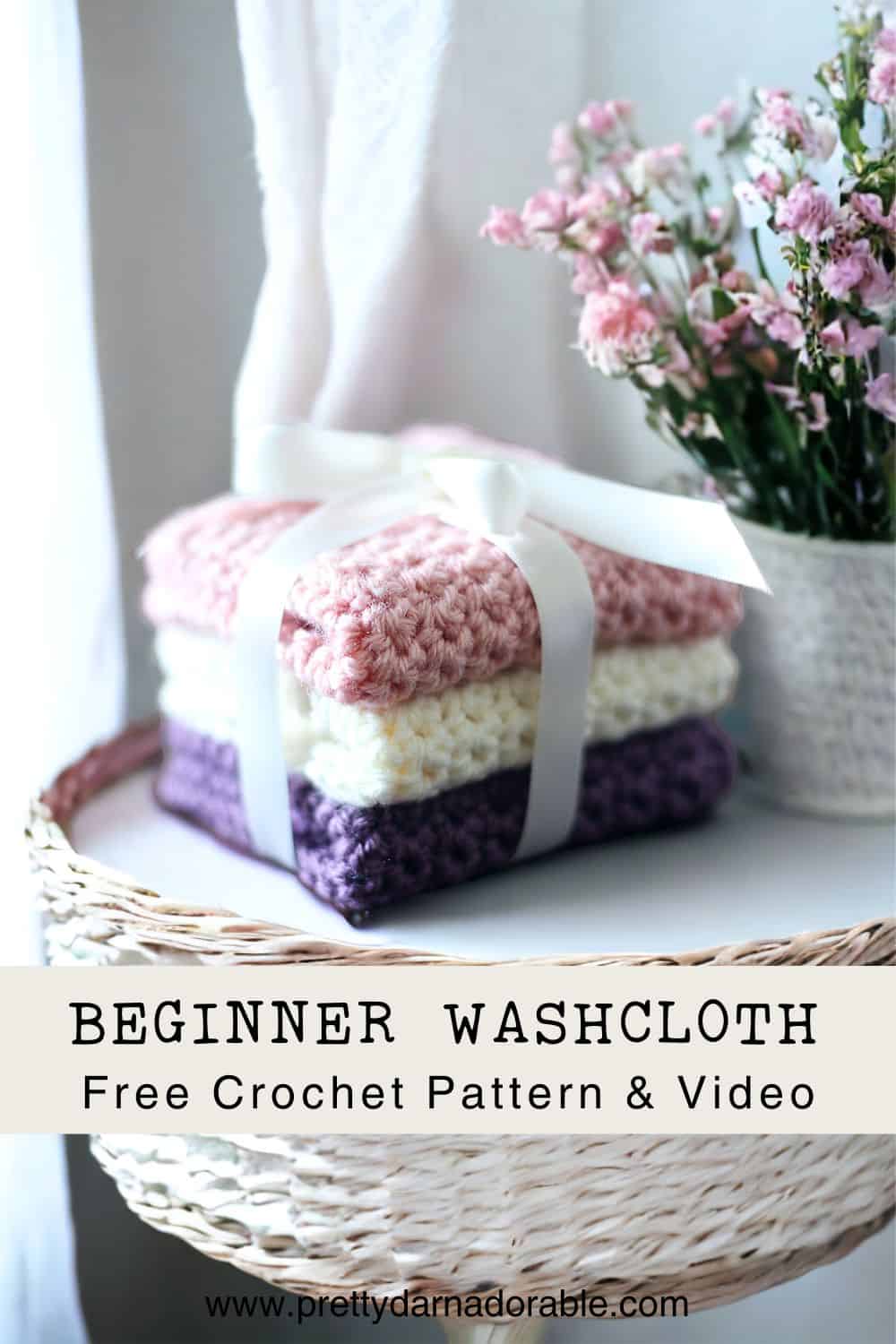 stack of crochet washcloths in purple pink and cream with a bow