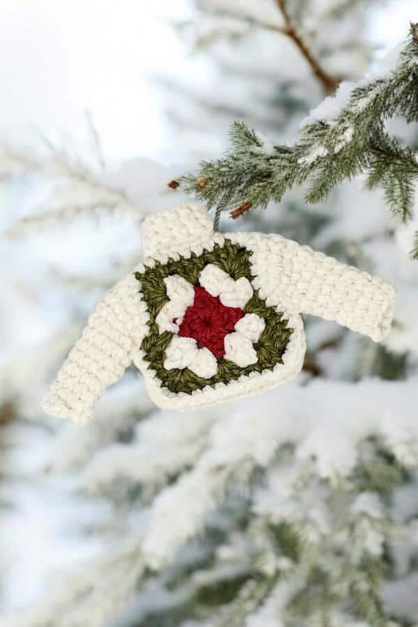 crochet granny square ornament hanging from a tree branch