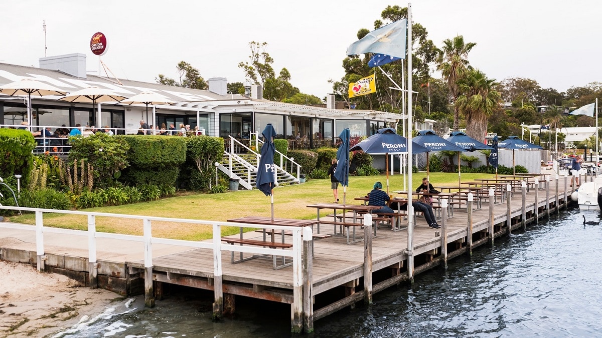 A group of people sitting at a dock