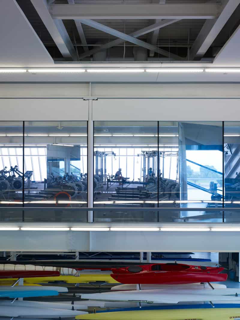 Devon Boathouse interior with rowing tanks and equipment reflecting OKC Boathouse District architecture and modern boathouse design by Rand Elliott Architects Oklahoma City.