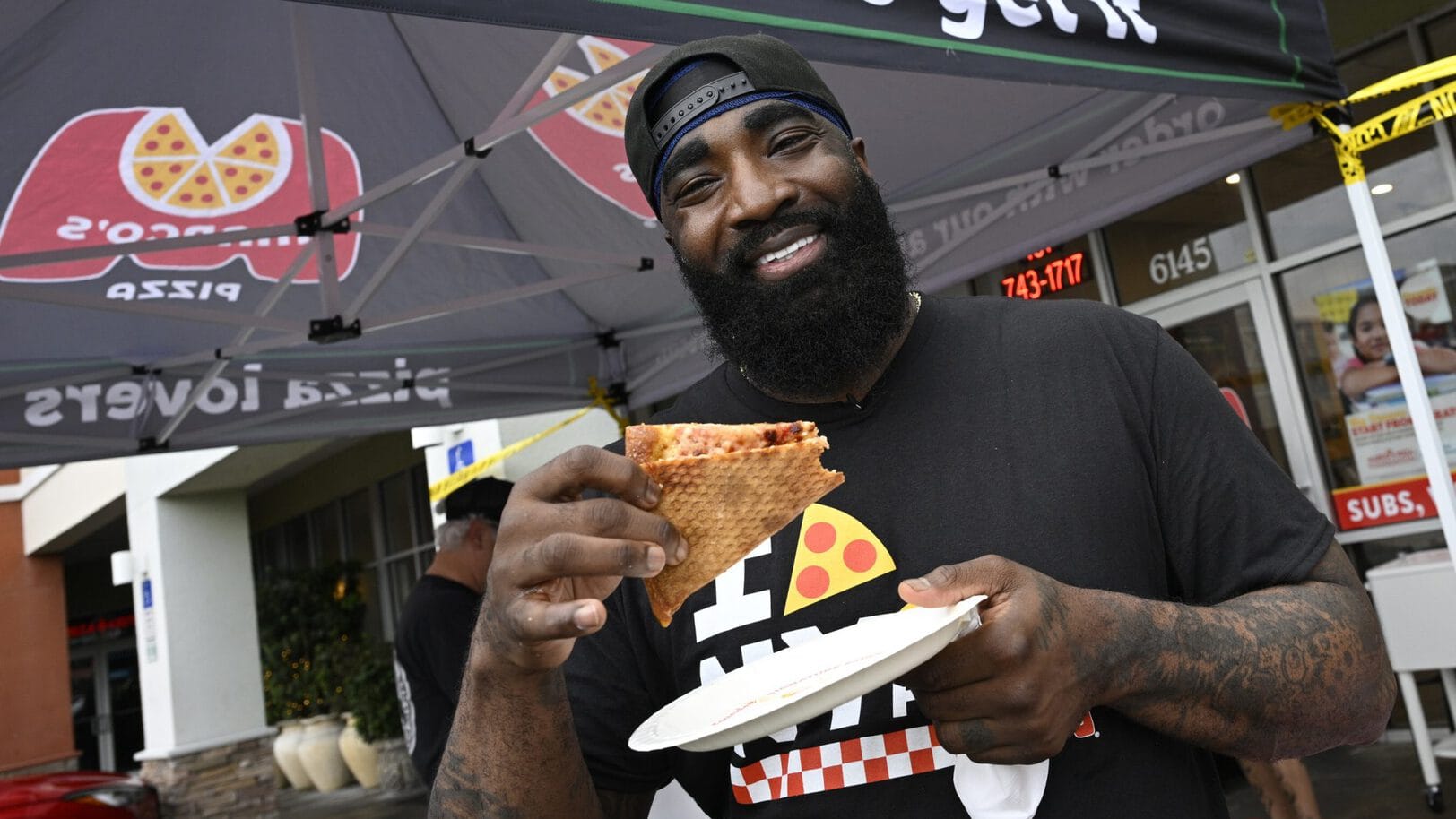 Basketball legend God Shammgod samples Marco’s new NY Style Pizza during the brand’s Orlando launch event. Image Courtesy of Marco’s Pizza